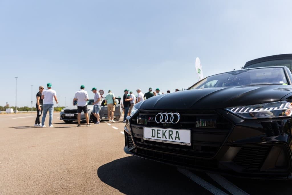 Trainingsfahrzeuge in Startaufstellung, im Hintergrund die Teilnehmergruppe